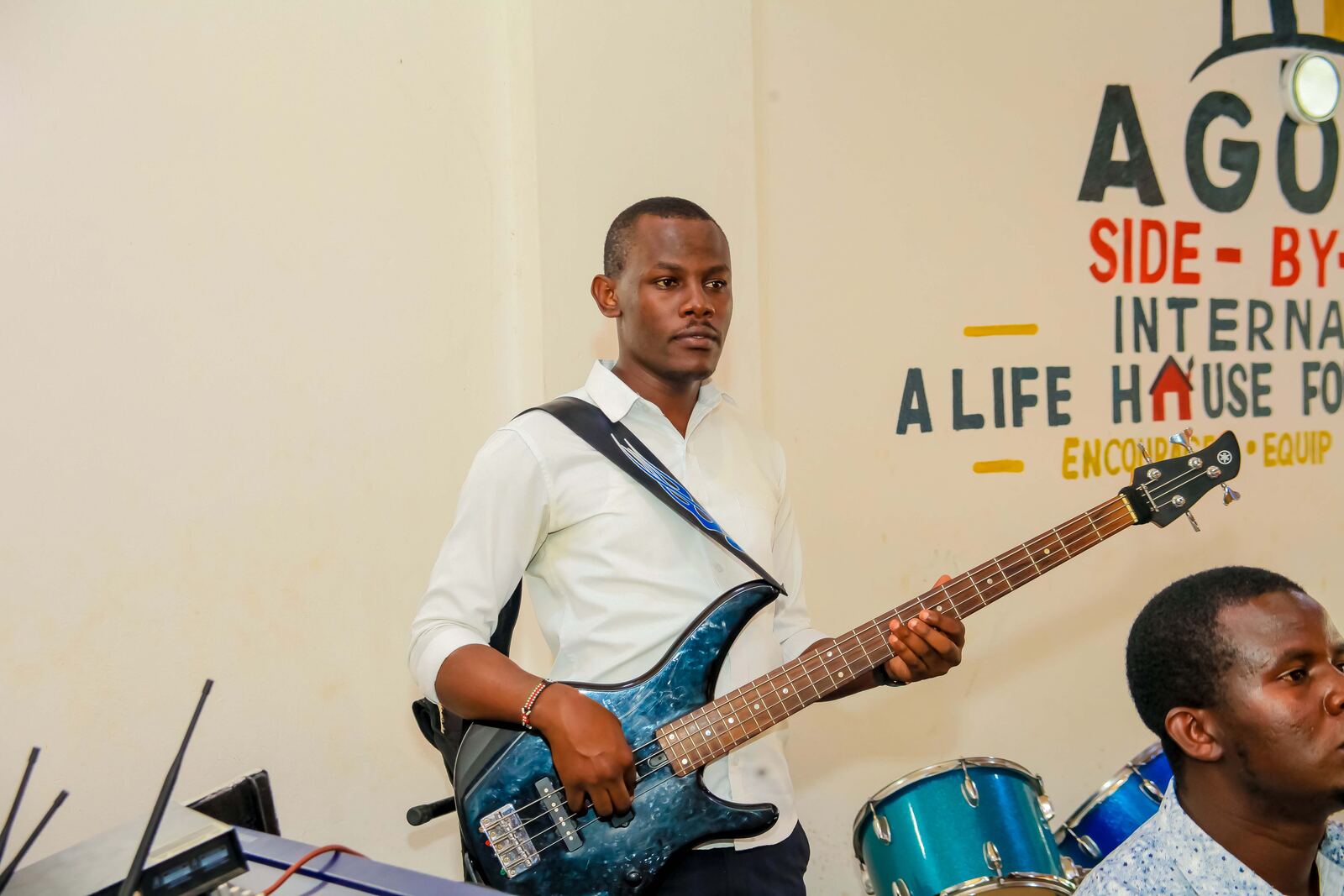 Musician playing guitar during a church gathering