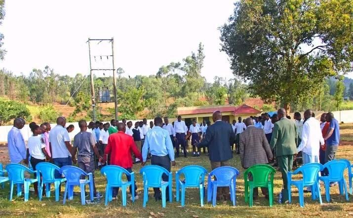 Congregation gathered together in prayer outdoors